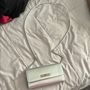 Silver crossbody evening bag with phone charger inside